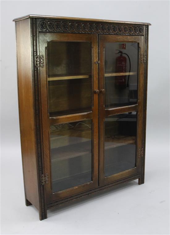An oak two door glazed bookcase, width 3ft 1in.